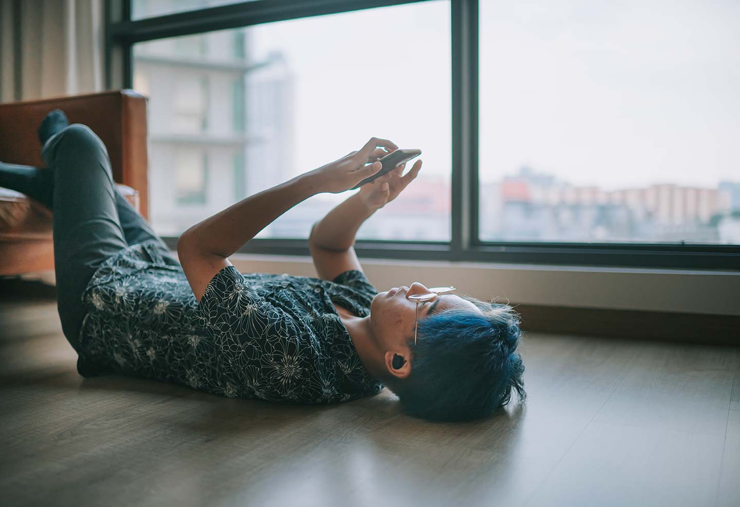 person laying on back using phone